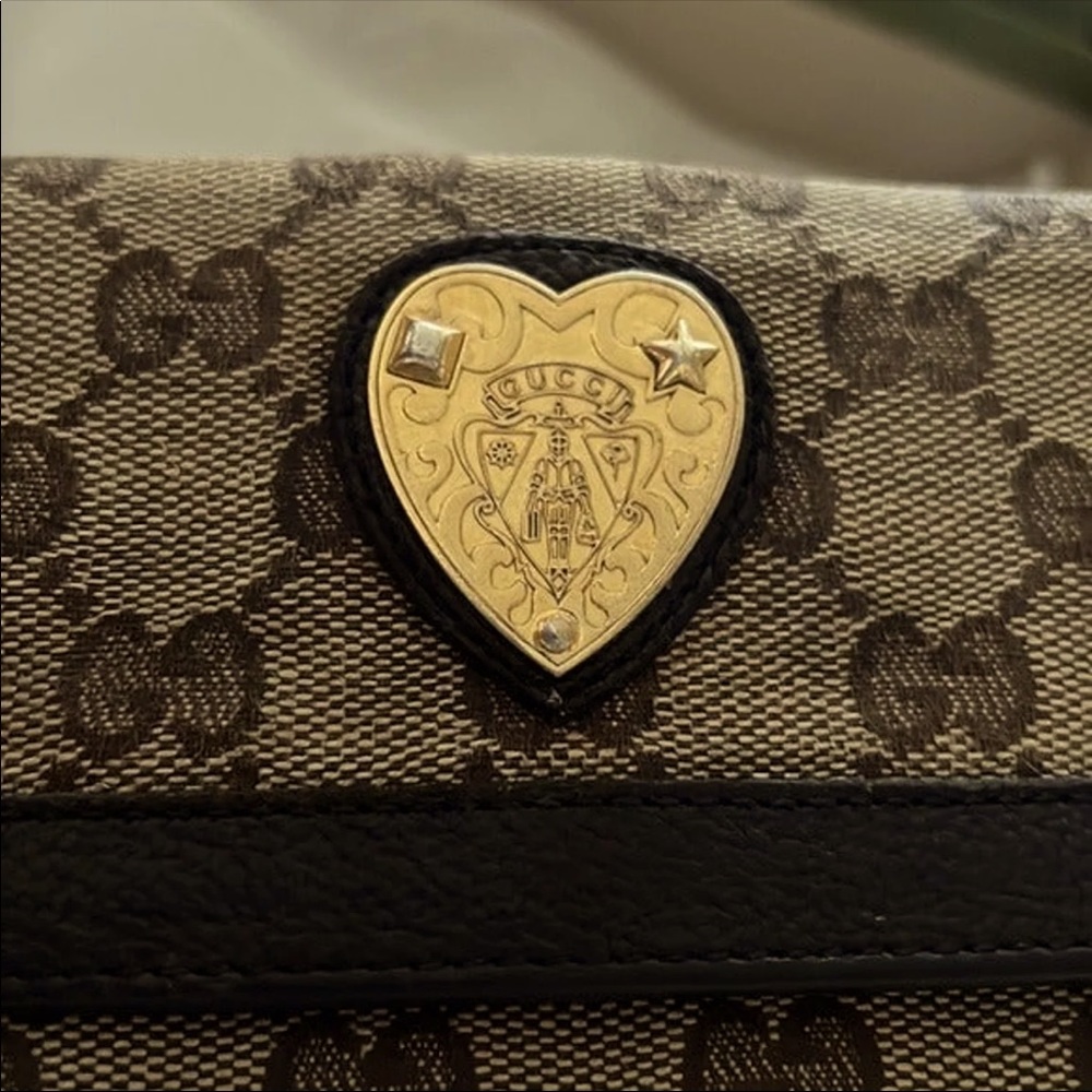 Authentic Gucci wallet used, but in good condition. Brown with tan